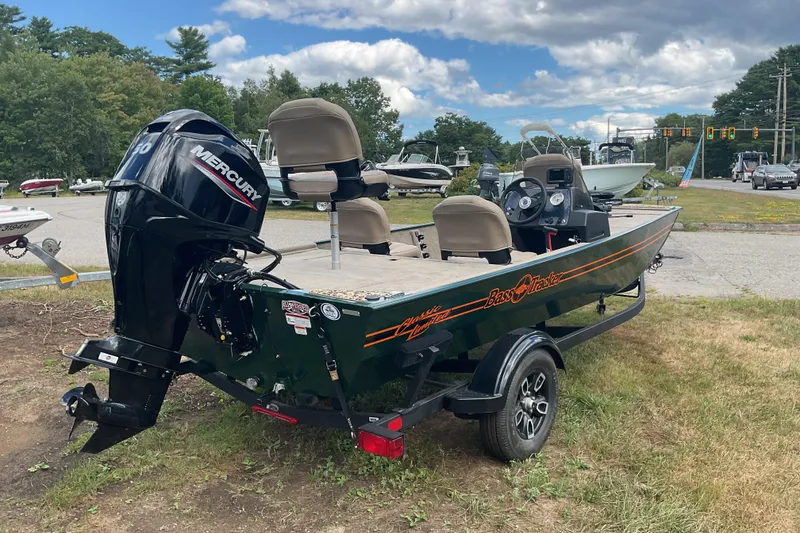 Slide: The Image of 2025 Tracker BT CLASSIC SE boat with Mercury engine on a trailer, parked outdoors. - 12