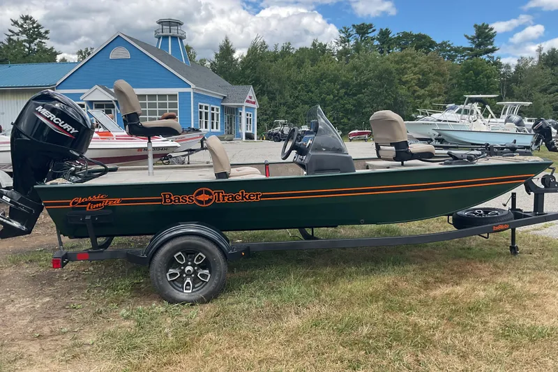 Slide: The Image of 2025 Tracker BT CLASSIC SE boat with Mercury engine on trailer, parked outdoors. - 13