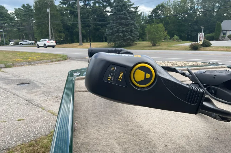 Slide: The Image of Trolling motor on a 2025 Tracker BT CLASSIC SE boat, parked near a road. - 15