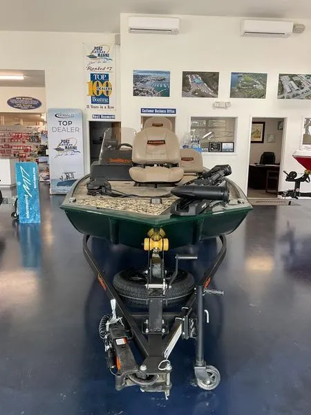 Slide: The Image of 2025 Tracker BT CLASSIC SE boat displayed in showroom with fishing equipment. - 3