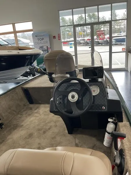 Slide: The Image of 2025 Tracker BT CLASSIC SE boat interior with steering wheel and navigation system. - 4