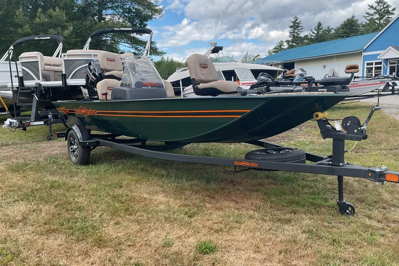 Slide: The Image of 2025 Tracker BT CLASSIC SE boat on trailer, parked outdoors near other boats. - 6