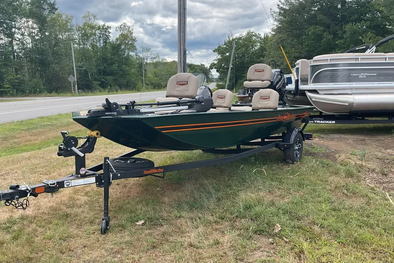 Slide: The Image of 2025 Tracker BT CLASSIC SE boat on trailer, parked on grass beside road. - 8