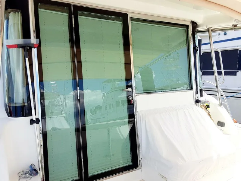 Slide: The Image of 2016 Sabre 48 Salon Express yacht with glass sliding doors and covered seating area. - 10