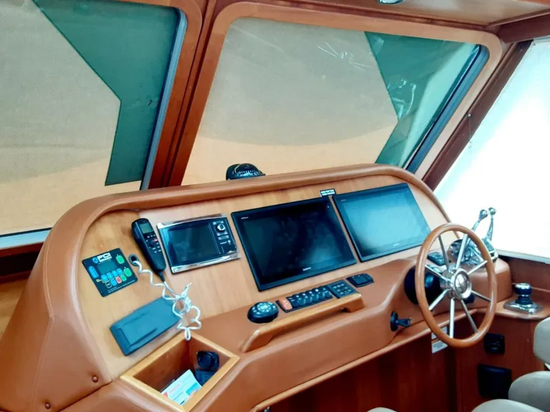 Slide: The Image of Helm of 2016 Sabre 48 Salon Express with navigation screens and steering wheel. - 14