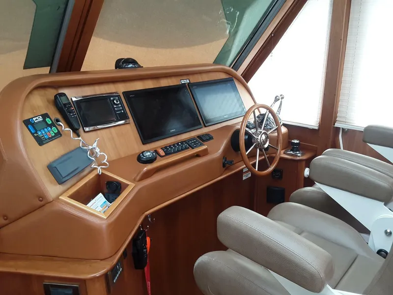 Slide: The Image of 2016 Sabre 48 Salon Express helm with modern navigation equipment and comfortable seating. - 15