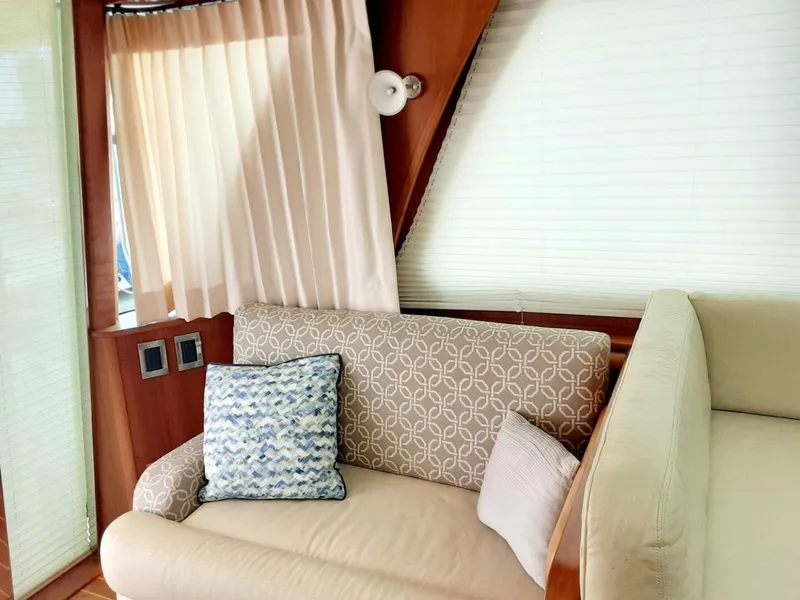 Slide: The Image of Interior of 2016 Sabre 48 Salon Express with elegant seating and decorative pillows. - 18