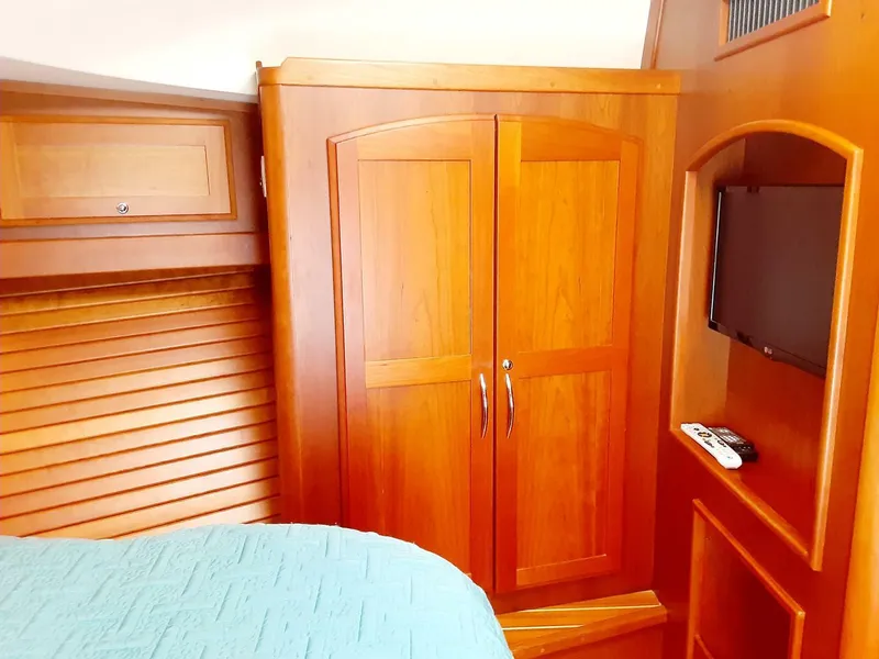 Slide: The Image of Interior of 2016 Sabre 48 Salon Express with wooden cabinetry and mounted TV. - 27