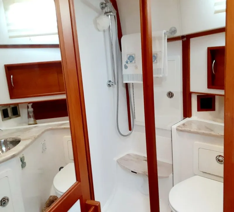 Slide: The Image of Bathroom interior of 2016 Sabre 48 Salon Express yacht, featuring shower and wooden accents. - 28