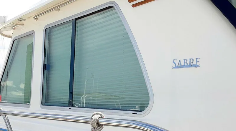 Slide: The Image of 2016 Sabre 48 Salon Express yacht with sleek window design and logo. - 33