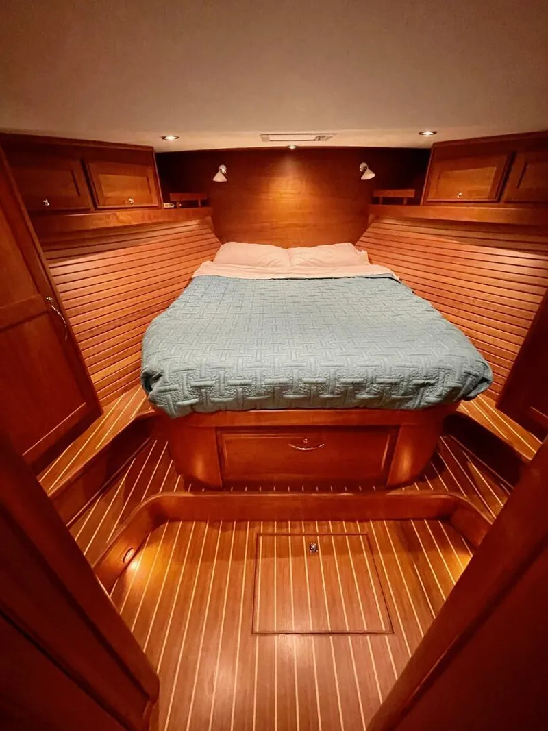 Slide: The Image of 2016 Sabre 48 Salon Express cabin with wooden interior and cozy bed. - 34
