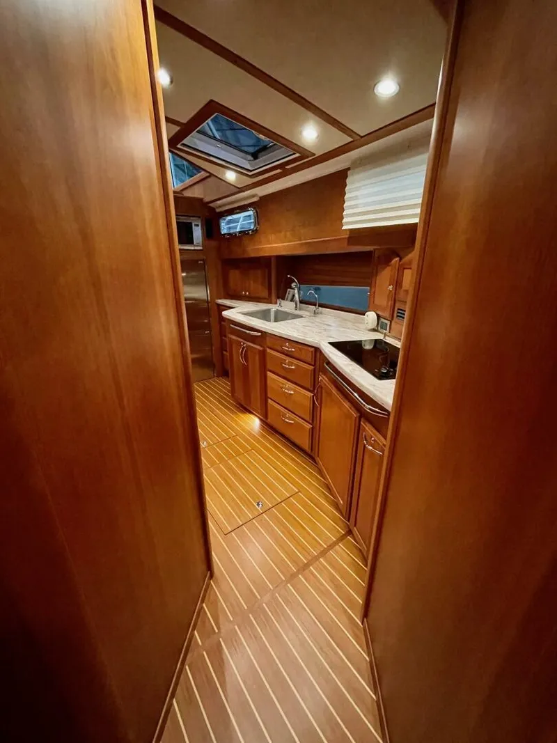 Slide: The Image of 2016 Sabre 48 Salon Express interior with wood finish and modern kitchen amenities. - 36