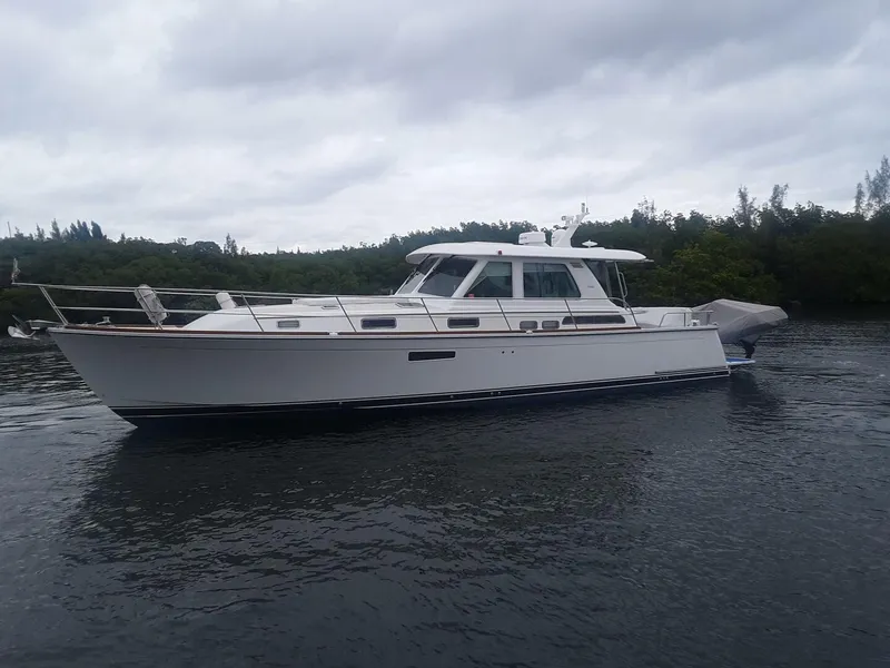 Slide: The Image of 2016 Sabre 48 Salon Express yacht cruising on a calm waterway. - 4