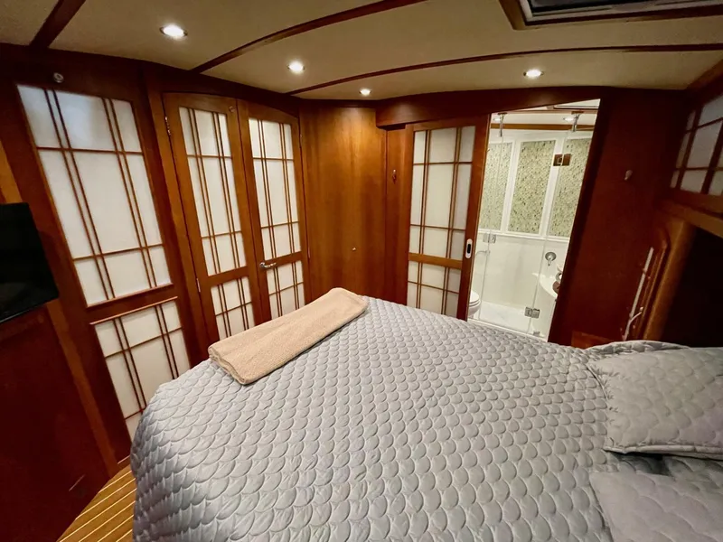 Slide: The Image of Luxurious bedroom interior of 2016 Sabre 48 Salon Express yacht with elegant wood paneling. - 45