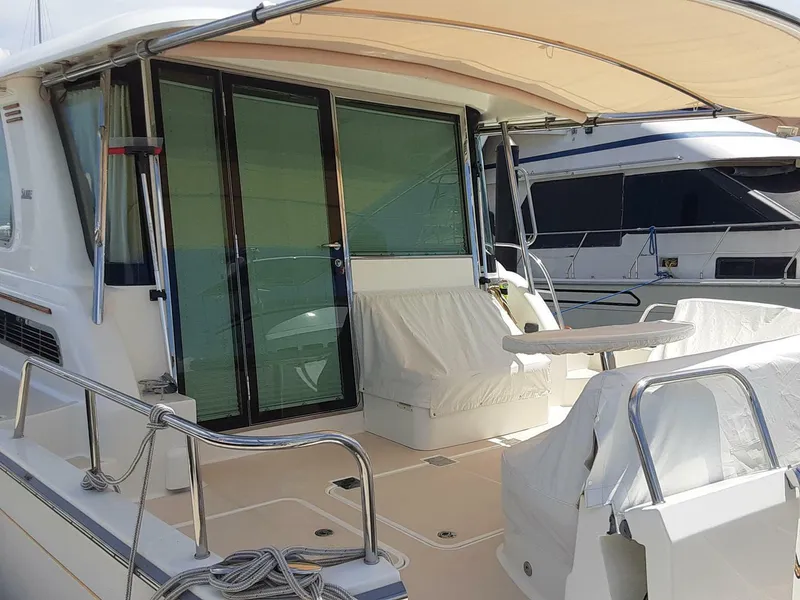 Slide: The Image of 2016 Sabre 48 Salon Express yacht with covered deck and seating area. - 8
