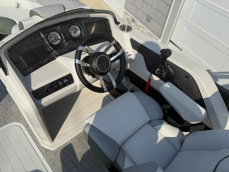 Slide: The Image of 2025 Avalon 2385 LSZ Quad Lounger boat cockpit with steering wheel and controls. - 20