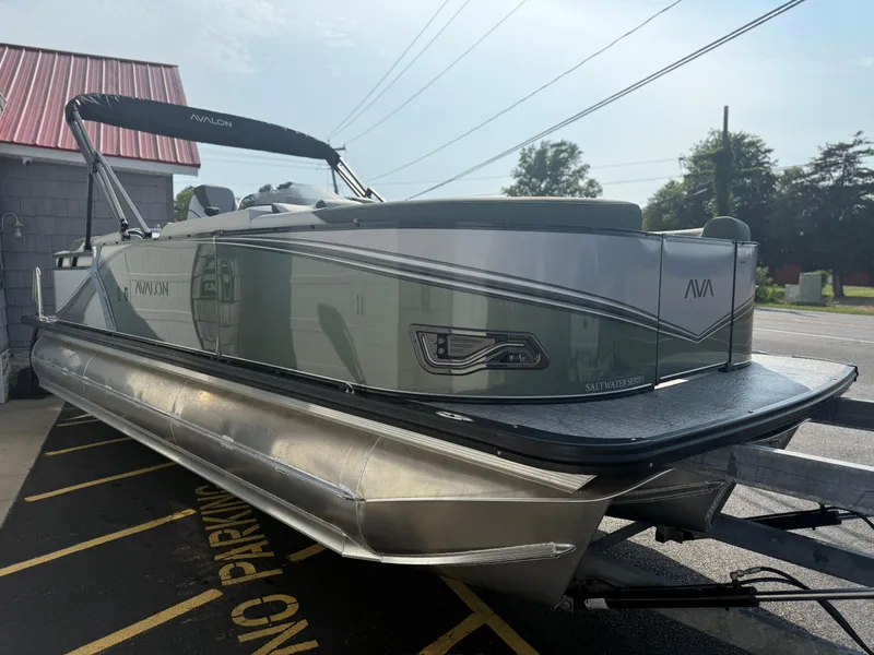 Slide: The Image of 2025 Avalon 2385 LSZ Quad Lounger Tri Toon boat, high performance, parked outdoors. - 6