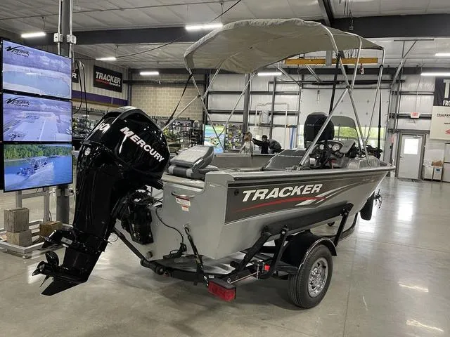 Slide: The Image of 2010 Tracker Pro-Guide V-16 SC boat with Mercury engine in showroom. - 10