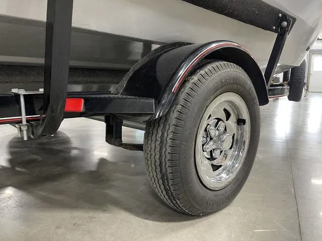 Slide: The Image of 2010 Tracker Pro-Guide V-16 SC trailer wheel and fender in a garage setting. - 11