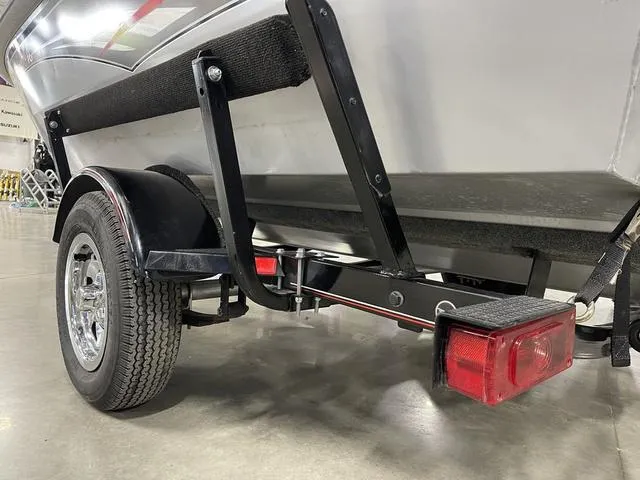 Slide: The Image of 2010 Tracker Pro-Guide V-16 SC boat trailer, close-up of wheel and taillight. - 12