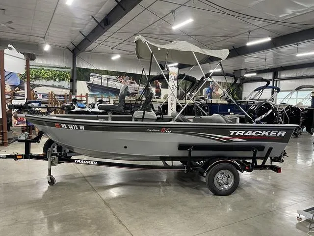 Slide: The Image of 2010 Tracker Pro-Guide V-16 SC boat with canopy in showroom. - 13