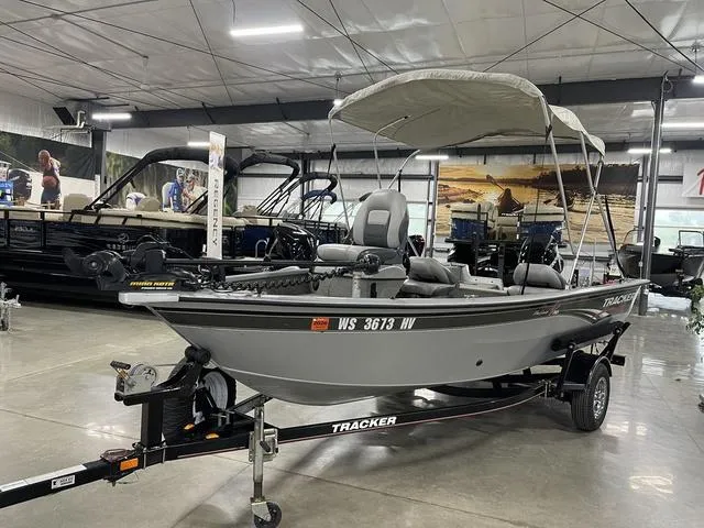 Slide: The Image of 2010 Tracker Pro-Guide V-16 SC boat with canopy on display in showroom. - 14