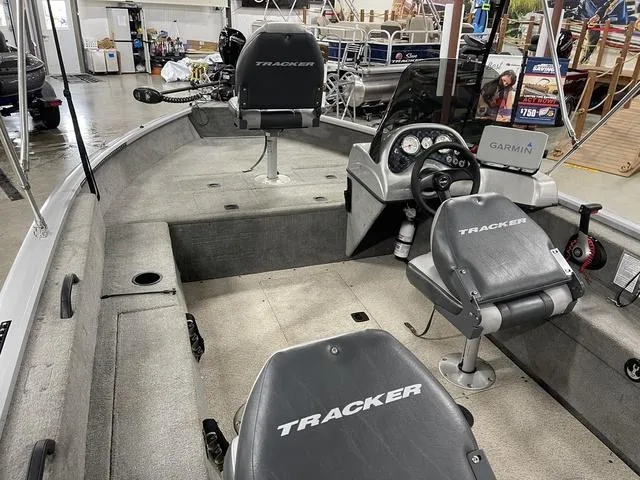 Slide: The Image of 2010 Tracker Pro-Guide V-16 SC boat interior with seating and Garmin equipment. - 19