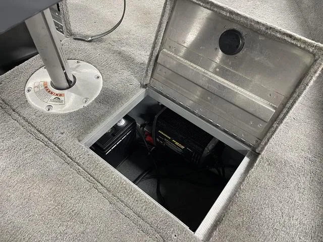 Slide: The Image of 2010 Tracker Pro-Guide V-16 SC boat battery compartment with open hatch. - 22
