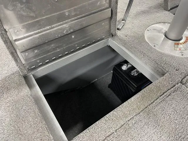 Slide: The Image of 2010 Tracker Pro-Guide V-16 SC boat battery compartment with open hatch. - 23