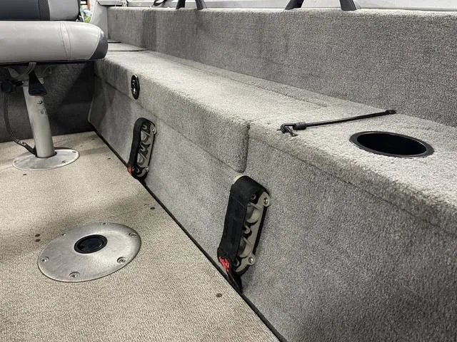 Slide: The Image of Interior of 2010 Tracker Pro-Guide V-16 SC boat, featuring seating and storage compartments. - 26