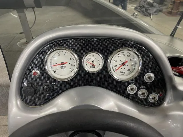 Slide: The Image of Dashboard of 2010 Tracker Pro-Guide V-16 SC boat with RPM, fuel, and speed gauges. - 28