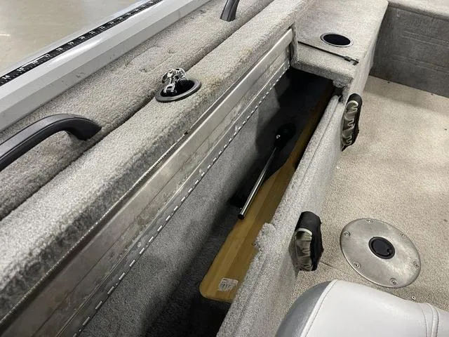 Slide: The Image of 2010 Tracker Pro-Guide V-16 SC boat interior with storage compartment and seating. - 32