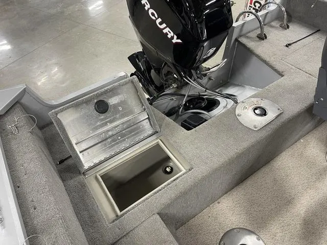 Slide: The Image of 2010 Tracker Pro-Guide V-16 SC boat interior with Mercury engine and storage compartment. - 33