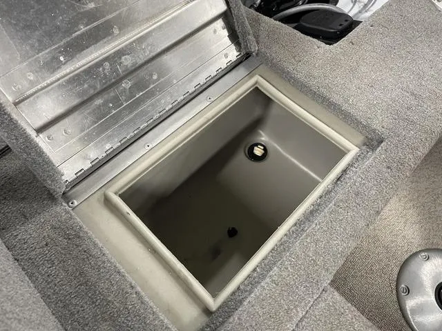 Slide: The Image of 2010 Tracker Pro-Guide V-16 SC boat storage compartment with open lid, showing interior space. - 34
