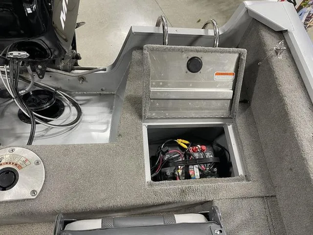 Slide: The Image of 2010 Tracker Pro-Guide V-16 SC boat battery compartment with open hatch and visible wiring. - 35