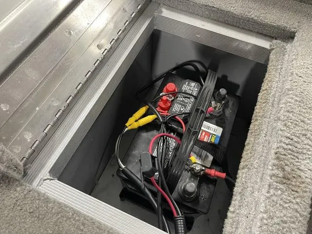 Slide: The Image of Battery compartment of 2010 Tracker Pro-Guide V-16 SC boat with connected cables. - 36