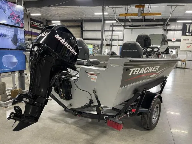 Slide: The Image of 2010 Tracker Pro-Guide V-16 SC boat with Mercury engine in a showroom. - 4