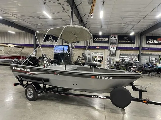 Slide: The Image of 2010 Tracker Pro-Guide V-16 SC boat on trailer in showroom. - 8