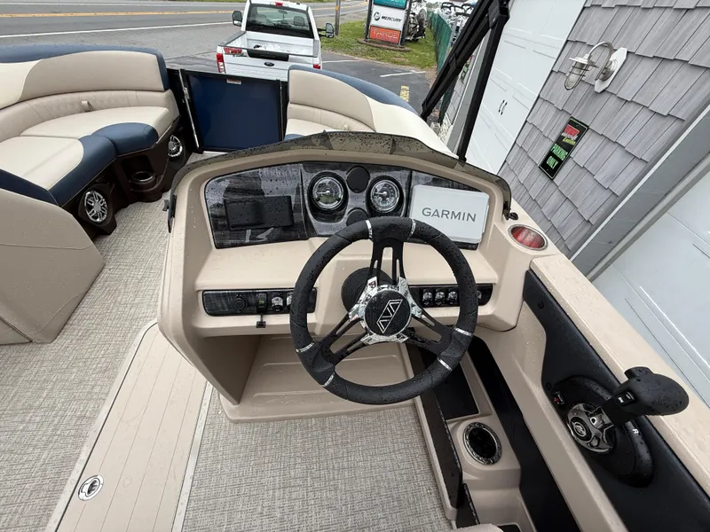 Slide: The Image of 2025 Avalon 2385 LSZ Quad Lounger Tri Toon boat with high performance features, parked outdoors. - 22