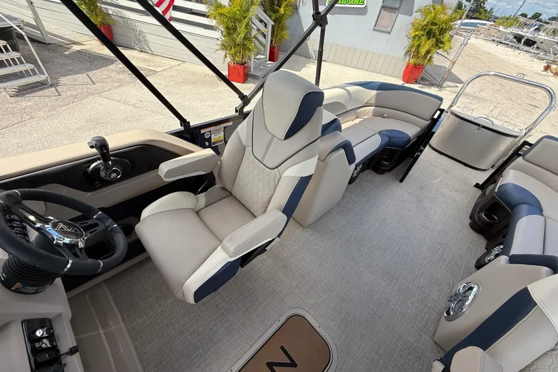 Slide: The Image of 2025 Avalon 2385 LSZ Quad Lounger interior, featuring luxurious seating and modern steering console. - 31