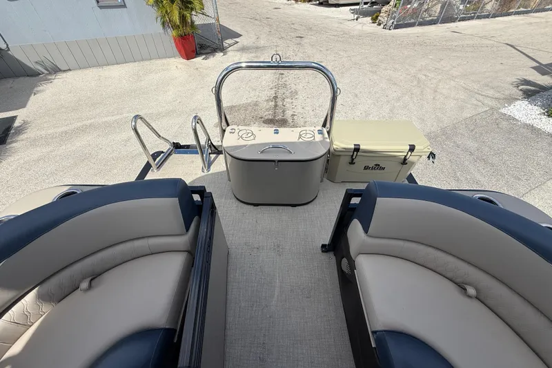 Slide: The Image of 2025 Avalon 2385 LSZ Quad Lounger Tri Toon boat interior with seating and cooler. - 35