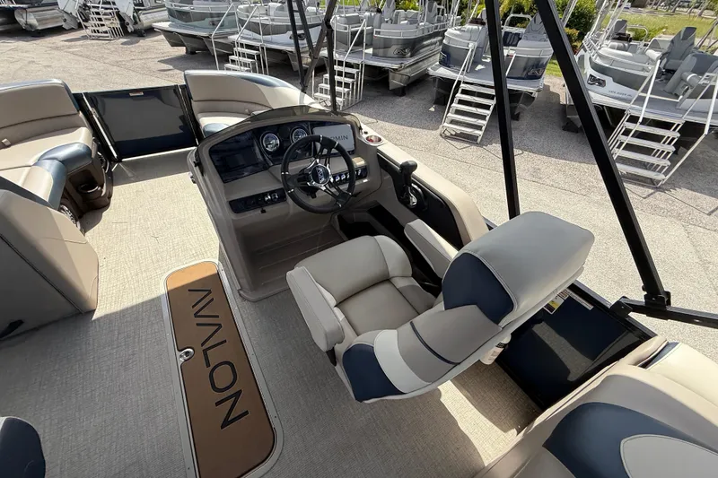 Slide: The Image of 2025 Avalon 2385 LSZ Quad Lounger boat interior with helm and seating. - 36