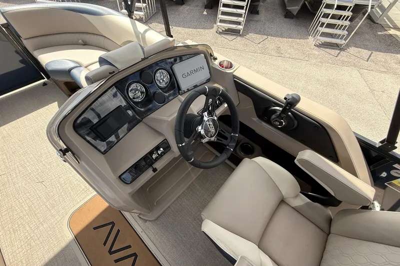 Slide: The Image of 2025 Avalon 2385 LSZ Quad Lounger boat interior with steering console and seating. - 38
