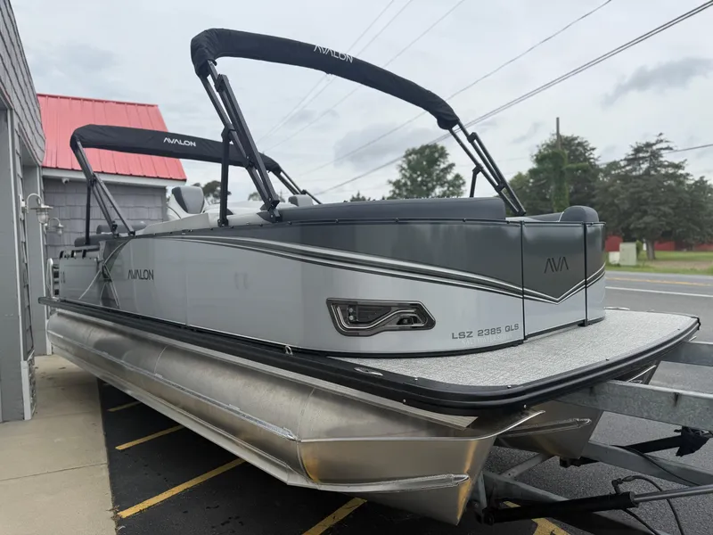 Slide: The Image of 2025 Avalon LSZ Quad Lounger 24' Tri Toon High Performance boat, parked outdoors. - 10