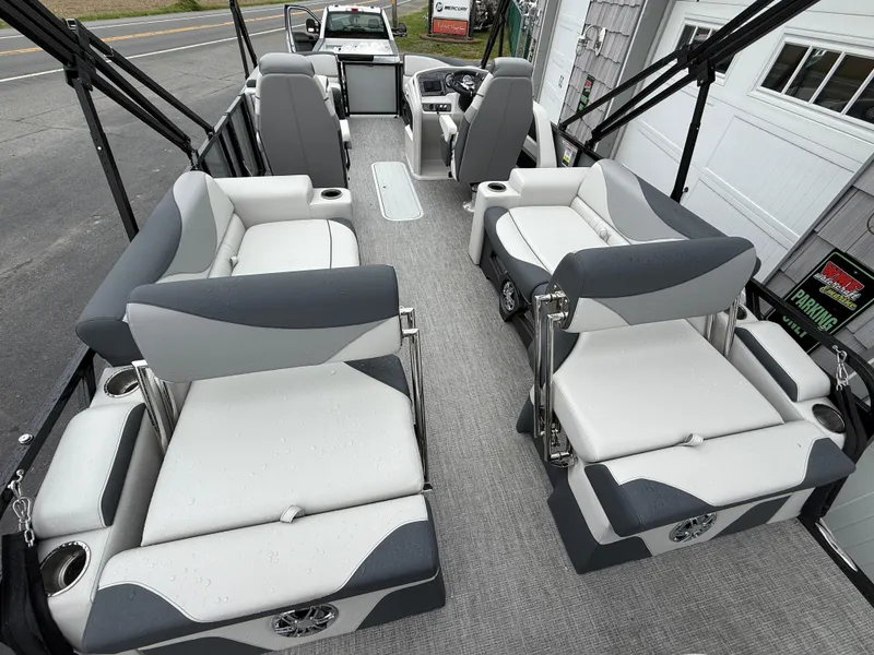 Slide: The Image of 2025 Avalon LSZ Quad Lounger boat interior with gray and white seating, spacious layout. - 13