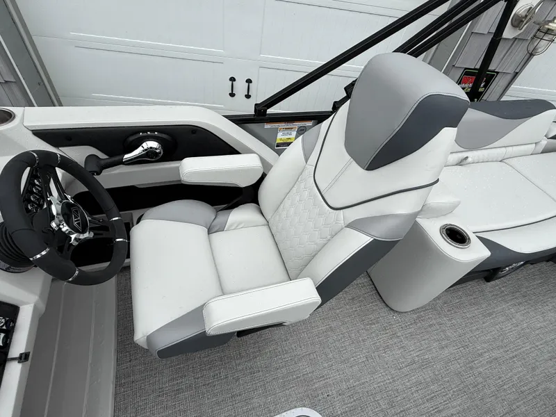 Slide: The Image of 2025 Avalon LSZ Quad Lounger boat interior with luxurious seating and modern steering wheel. - 18