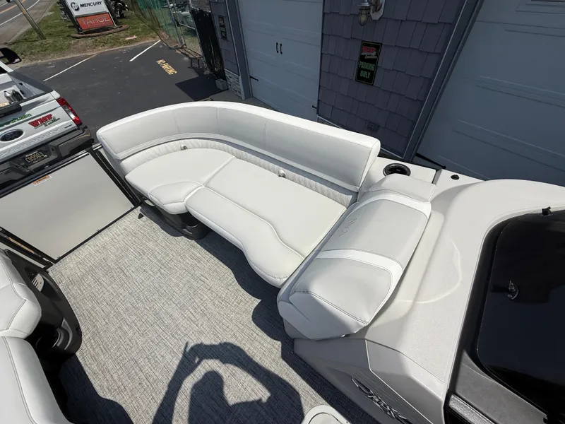 Slide: The Image of 2025 Avalon 2385 Catalina Quad Lounger with white seating and gray flooring, parked outdoors. - 15