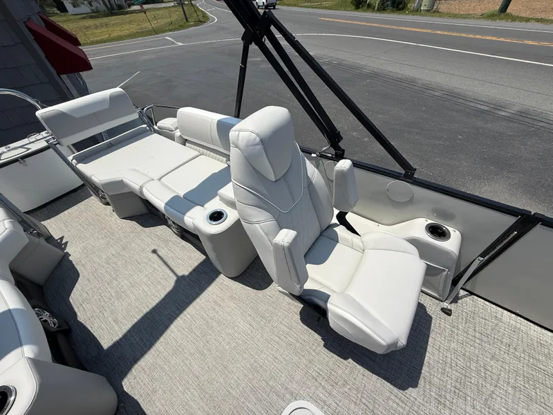 Slide: The Image of 2025 Avalon 2385 Catalina Quad Lounger with plush seating and cup holders on a sunny day. - 20