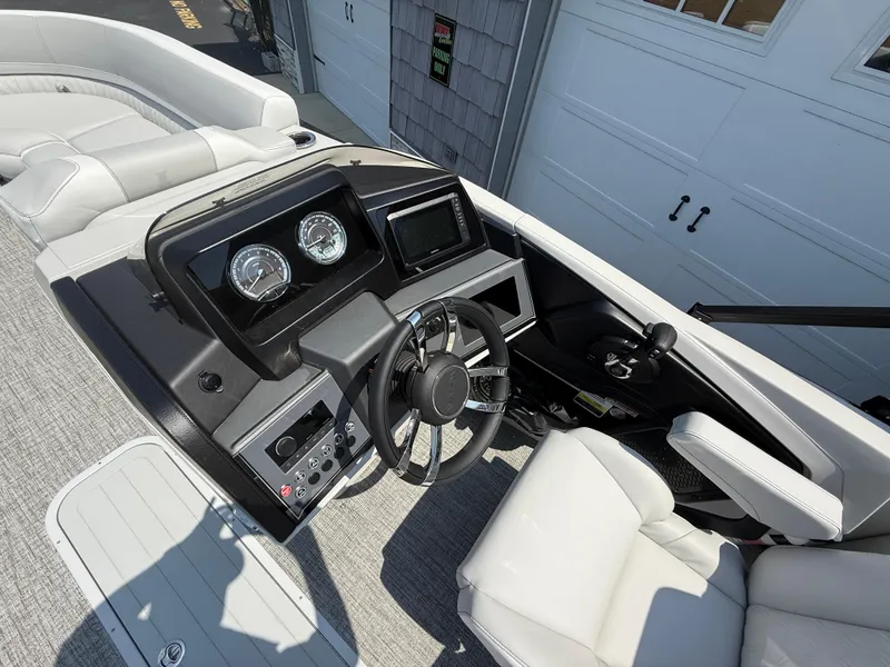 Slide: The Image of 2025 Avalon 2385 Catalina Quad Lounger helm with modern controls and comfortable seating. - 21
