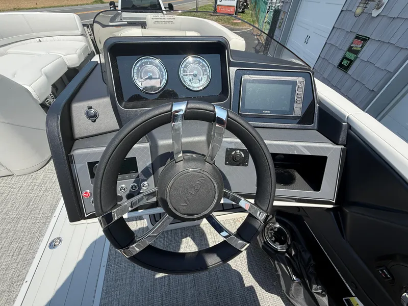 Slide: The Image of Steering console of 2025 Avalon 2385 Catalina Quad Lounger, featuring modern gauges and controls. - 23